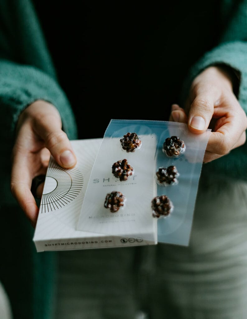 Close-up of hands holding fresh psilocybin truffles, used for microdosing to enhance focus and well-being.